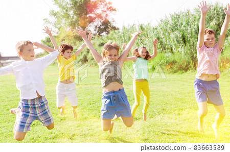 Kids jumping and raising hands Kids jumping and raising hands 83663589