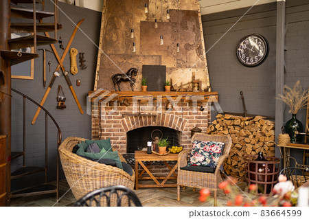 brick fireplace in retro style in a country house. interior in vintage style. brick fireplace in retro style in a country house. interior in vintage style. 83664599