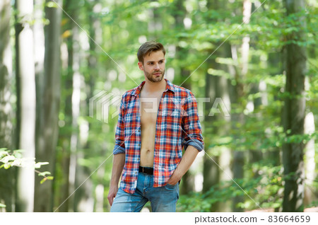 handsome man with bristle wear checkered shirt outdoor, male sexuality 83664659