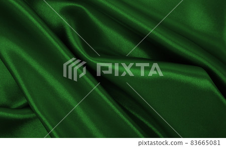 Smooth elegant green silk or satin luxury cloth texture as abstract background. Luxurious background design 83665081