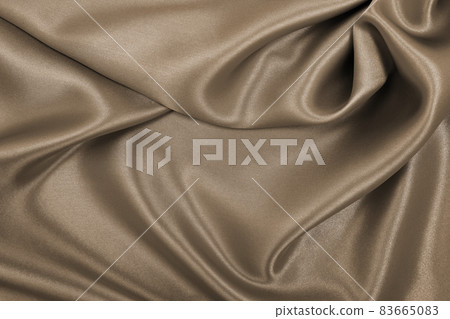 Smooth elegant brown silk or satin texture as abstract background. Luxurious background design. In Sepia toned. Retro style Smooth elegant brown silk or satin texture as abstract background. Luxurious background design. In Sepia toned. Retro style 83665083