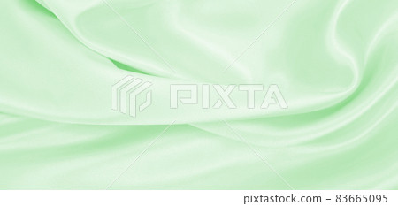 Smooth elegant green silk or satin luxury cloth texture as abstract background. Luxurious background design Smooth elegant green silk or satin luxury cloth texture as abstract background. Luxurious background design 83665095