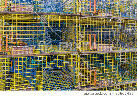 Empty stacked lobster traps on a dock in Maine Empty stacked lobster traps on a dock in Maine 83665455