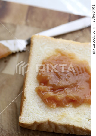 Plenty of peanut cream spread on bread Plenty of peanut cream spread on bread 83666401