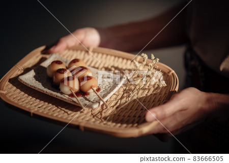 Roasted Mitarashi Dango in the wooden tray, one of the most popular Japanese street food. 83666505