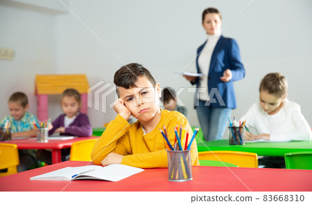 Upset boy in schoolroom 83668310