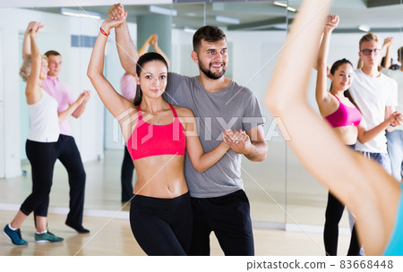 Friendly dancing pair dance tango together Friendly dancing pair dance tango together 83668448