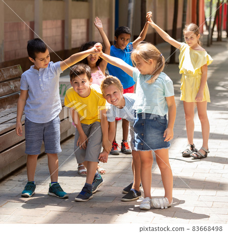 Energetic children play a game called trickle on the street 83668498