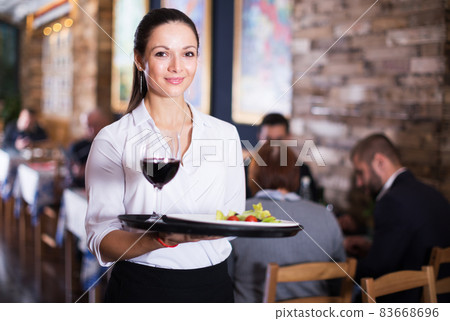 Waitress standing in restaurant Waitress standing in restaurant 83668696