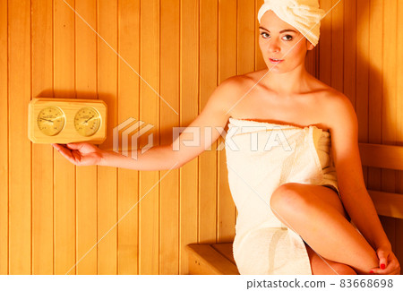 woman relaxing in wooden sauna room woman relaxing in wooden sauna room 83668698