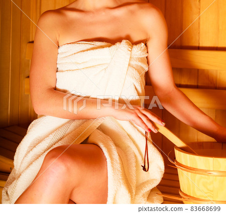 woman relaxing in wooden sauna room woman relaxing in wooden sauna room 83668699