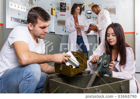 Friends inspecting box with facilities in quest room Friends inspecting box with facilities in quest room 83668790