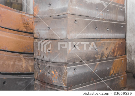 Cast iron tubing reinforced concrete cast products for lining distillation tunnels and underground structures are stored in the warehouse of the industrial plant Cast iron tubing reinforced concrete cast products for lining distillation tunnels and underground structures are stored in the warehouse of the industrial plant 83669529