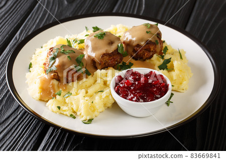 Scandinavian Meatball Lihapullat with mashed potatoes and lingonberry jam close-up in a plate. Horizontal 83669841