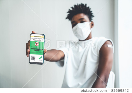 Young Asian woman shows vaccine passport on mobile phone 83669842