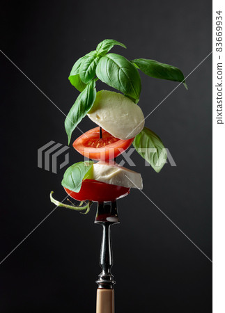 Mozzarella with tomato and basil. 83669934