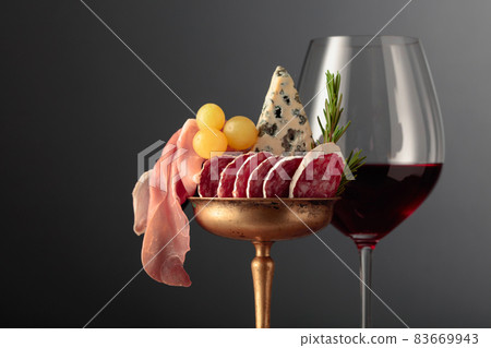 Wine, blue cheese, dry-cured sausage, grapes, and rosemary. 83669943