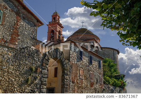 Castiglione del Lago Trasimeno, Umbria, Italy. August 2020. One of the access doors of the walls of the historic village, the church bell tower is recognizable. Castiglione del Lago Trasimeno, Umbria, Italy. August 2020. One of the access doors of the walls of the historic village, the church bell tower is recognizable. 83671367