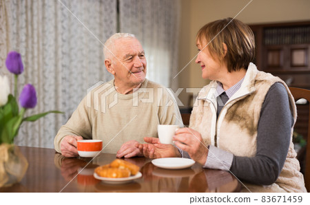 Elderly man and woman enjoying conversation 83671459