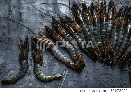 Raw tiger prawns on grey clay background 83672931