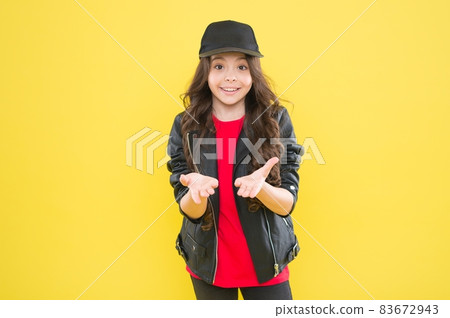 Happy little girl with cool look in fashion wear hold open Happy little girl with cool look in fashion wear hold open 83672943