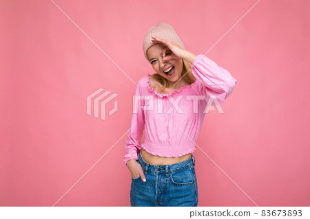 Photo of beautiful happy amusing young blonde female person isolated over pink background wall Photo of beautiful happy amusing young blonde female person isolated over pink background wall 83673893