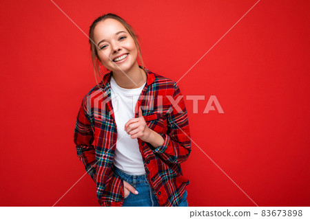 Portrait of young attractive smiling hipster blonde woman in stylish red shirt and casual white t Portrait of young attractive smiling hipster blonde woman in stylish red shirt and casual white t 83673898