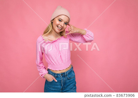 Photo of beautiful happy smiling young blonde woman isolated over pink background wall wearing Photo of beautiful happy smiling young blonde woman isolated over pink background wall wearing 83673906