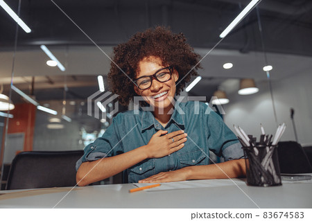 Smiling young Afro American woman speaking sign language Smiling young Afro American woman speaking sign language 83674583