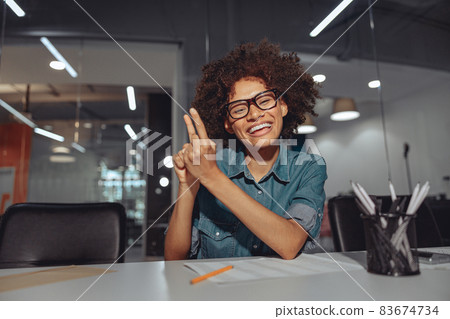 Pretty young woman speaking in sign language in the office 83674734
