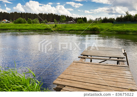 Old wooden pier on the river. Countryside view Old wooden pier on the river. Countryside view 83675022
