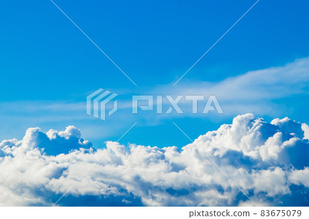 White fluffy cumulus clouds against a clear blue sky. A symbol of dreams and freedom. Background for design. White fluffy cumulus clouds against a clear blue sky. A symbol of dreams and freedom. Background for design. 83675079