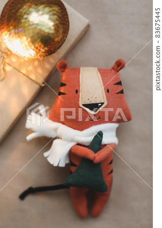 Christmas composition with a tiger toy, symbol of new 2022, a gift and decorations. Christmas, winter, new year concept. Flat lay, top view 83675445