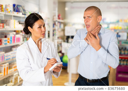 Asian female pharmacist consulting man in drugstore 83675680