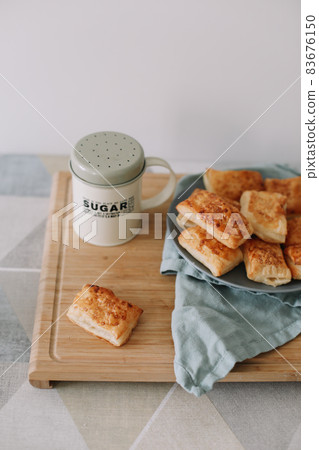freshly baked homemade pastry on kitchen table. breakfast with puff buns  83676150