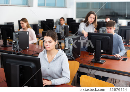 Focused female student works at computer Focused female student works at computer 83676534