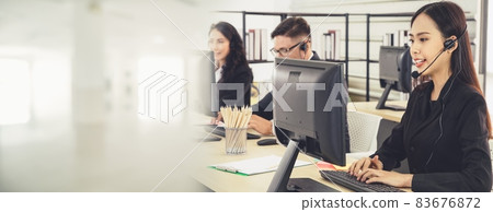 Business people wearing headset working in office broaden view Business people wearing headset working in office broaden view 83676872
