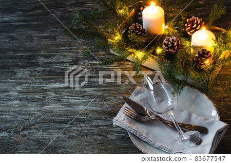 Christmas table setting with candles and fir branches 83677547