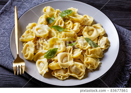 tortelloni with cheese filling on a plate 83677861