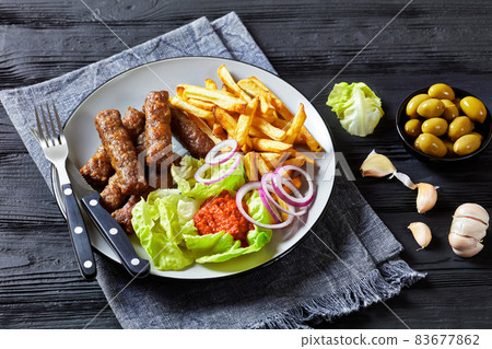 cevapcici with potato fries, lettuce, onion, ajvar 83677862