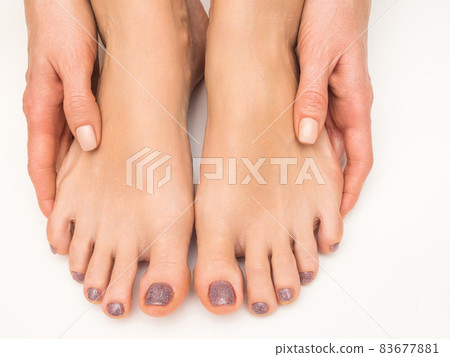 Hands and feet of a young girl with manicure and pedicure on a white background. Close-up. Hands and feet of a young girl with manicure and pedicure on a white background. Close-up. 83677881