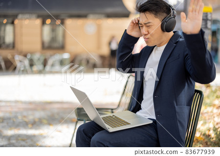 Irritated business man working on laptop outdoors Irritated business man working on laptop outdoors 83677939