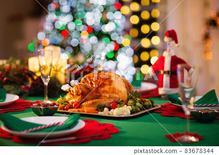 Christmas dinner at fire place and Xmas tree. Christmas dinner at fire place and Xmas tree. 83678344