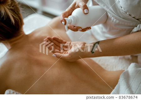 confident female specialist is doing relaxing body massage for beautyful slim caucasian lady at minimalistic spa salon confident female specialist is doing relaxing body massage for beautyful slim caucasian lady at minimalistic spa salon 83678674