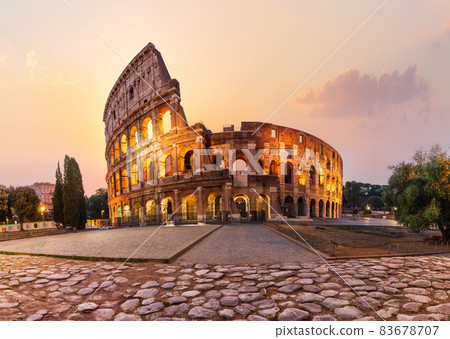 Roman Coliseum illuminated at sunrise, summer view without people, Rome, Italy 83678707