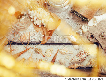 a lot of sea theme in mess like shells, candles, perfume, girl stuff on linen, pretty textured post card view vintage 83678821