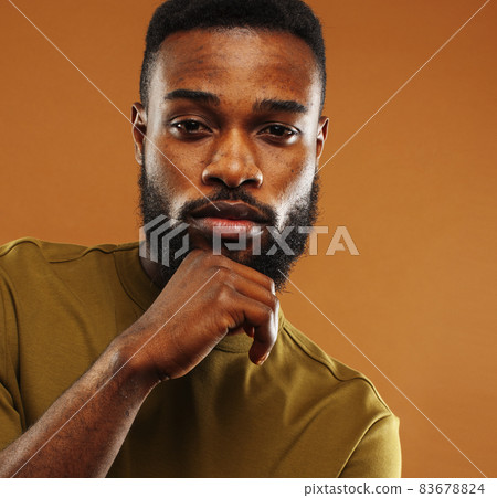 young pretty african american man posing cheerful on brown background, lifestyle people concept 83678824