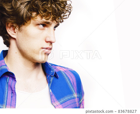 young handsome teenage hipster guy posing emotional, happy smiling against white background isolated, lifestyle people concept 83678827