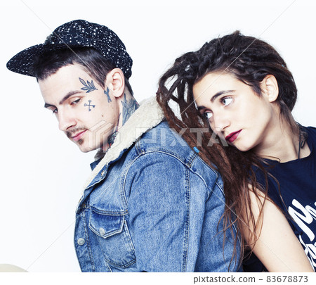 Young couple together. guy with tattoo, girlfriend wearing dreadlocks having fun on white background 83678873