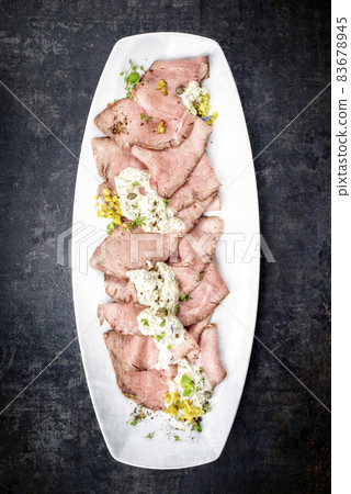 Traditional lunch meat with sliced cold cuts roast beef and remoulade Traditional lunch meat with sliced cold cuts roast beef and remoulade 83678945